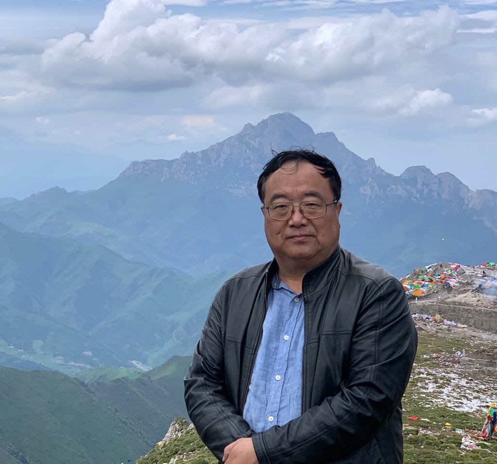 Man standing in front of mountains