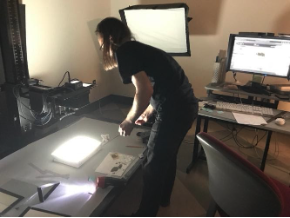Chris Antkowiak (CUL Preservation & Digital Conversion Division) prepares to photograph decaying nitrate negatives using a light box. Due to the risk of combustion, the negatives were stored in a refrigerator and individually removed by the photographer just prior to imaging. 
